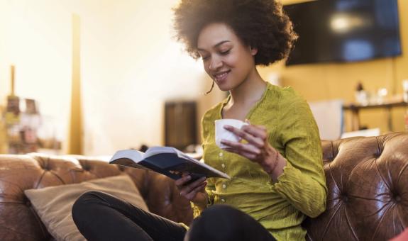 Woman enjoying coffee and a book