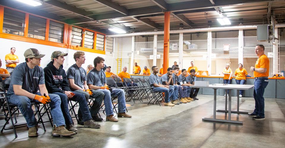 Image of students learning from Spire employees in a warehouse 