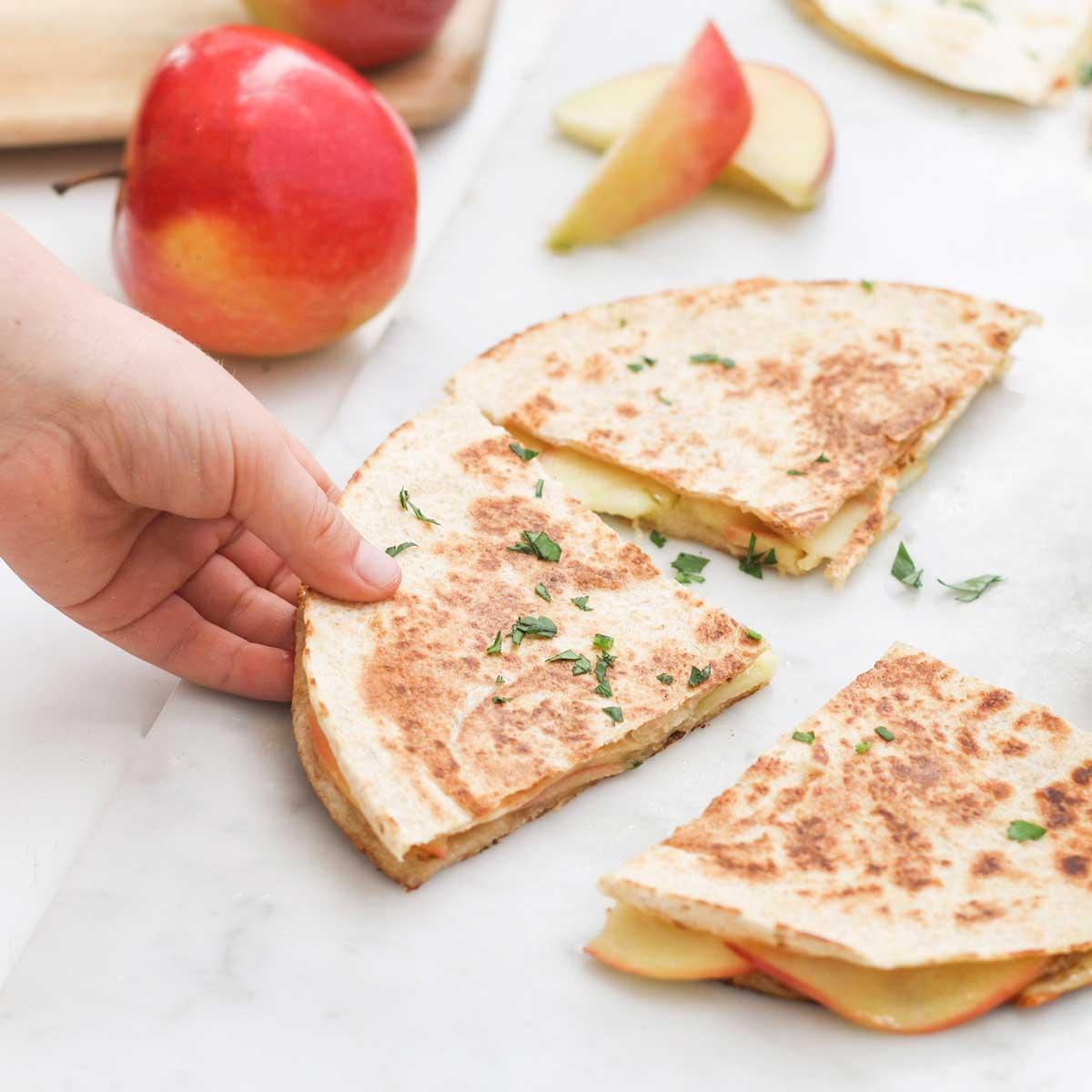 Image of hand grabbing quesadillas