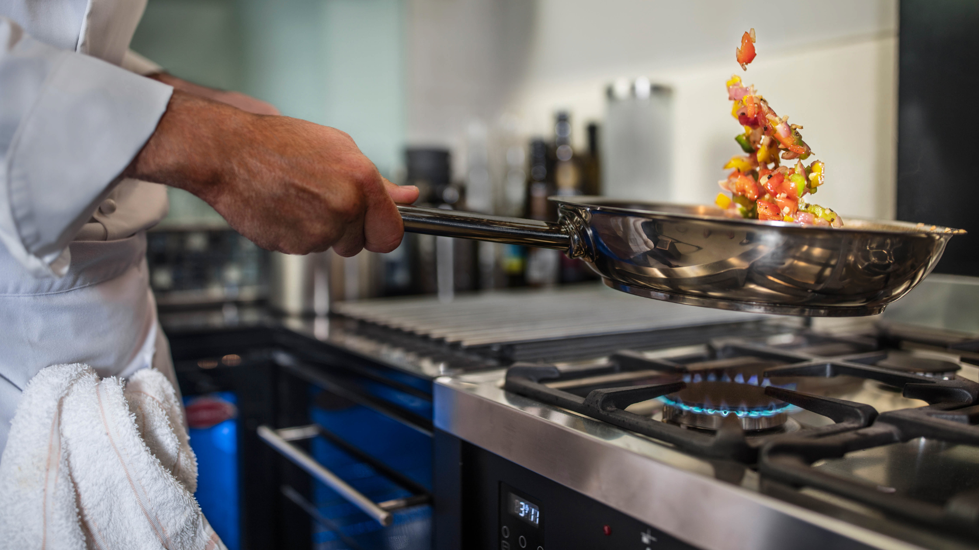 Image of a hand tossing a pan 